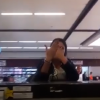 A woman smashes up a check-in desk at the airport