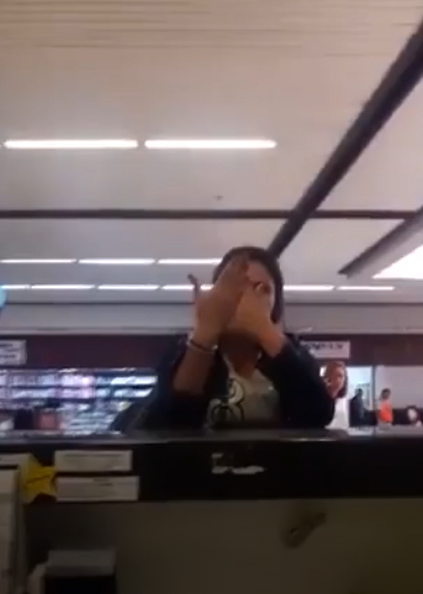 A woman smashes up a check-in desk at the airport