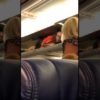 Southwest flight attendant welcomes passengers being in the overhead bin